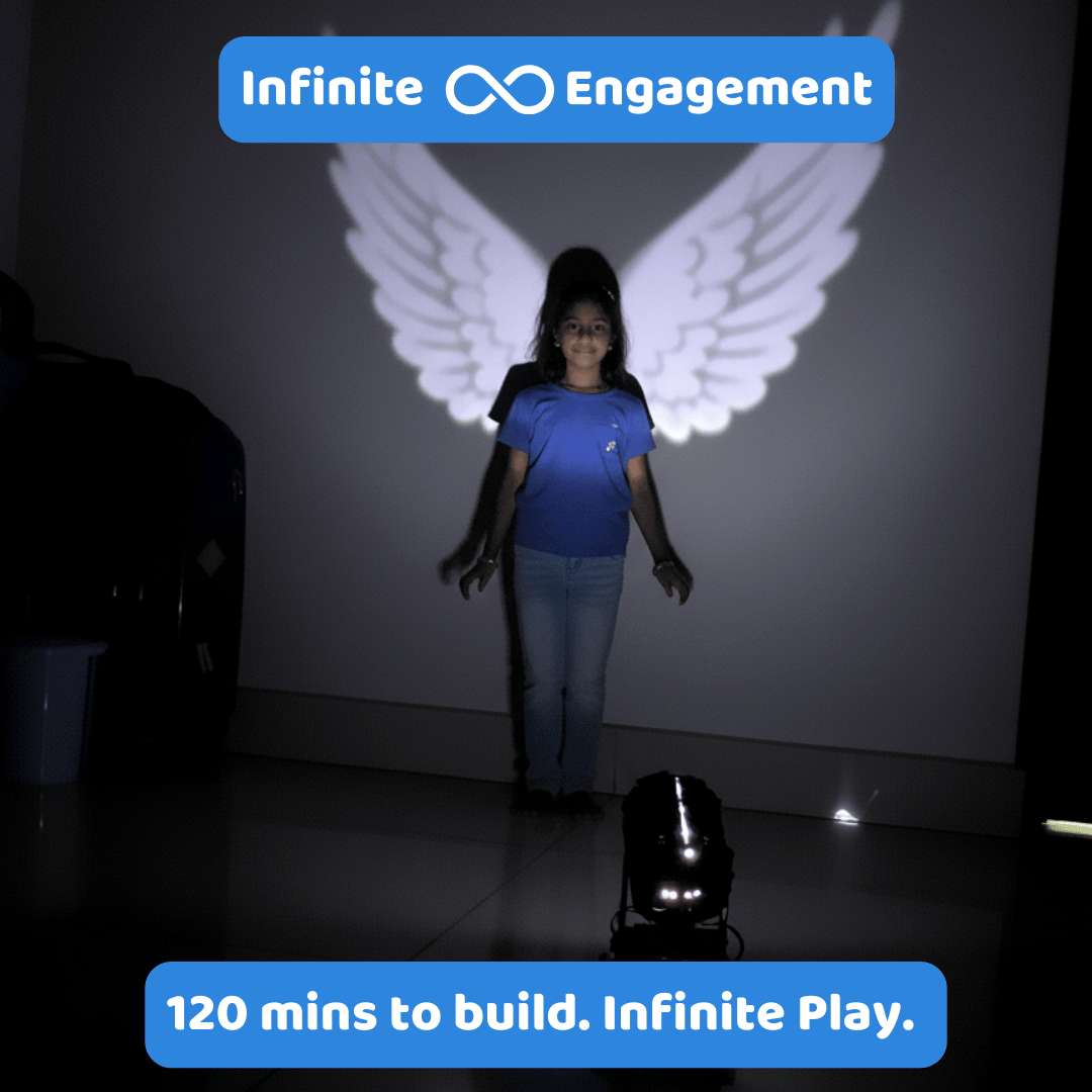 Person standing in front of a screen with projected wings, with 'Infinite Engagement' branding.