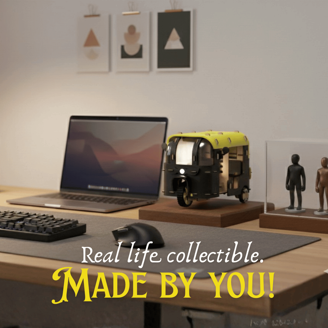 Desk setup with laptop, keyboard, mouse, and model vehicle with text 'Real life collectible. Made by you!'